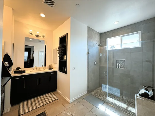 a bedroom with a bed window and mirror