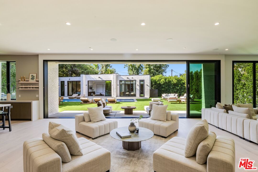 17055 Rancho Street Encino, CA 91316 - Photo 29 of 73 a living room with furniture and a large window