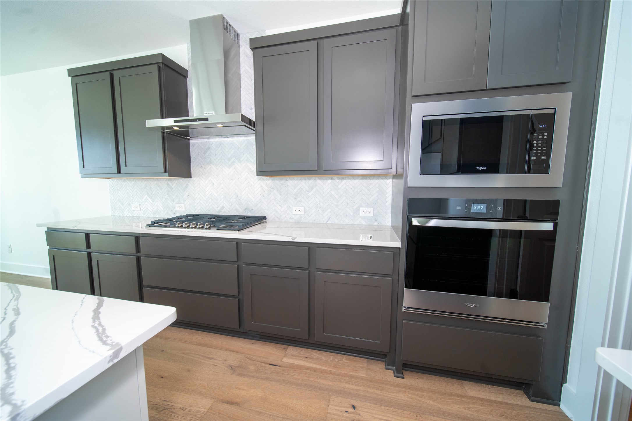 2029 Varese Path Leander, TX 78641 - Photo 23 of 32 a kitchen with stainless steel appliances kitchen island granite countertop a refrigerator and a stove top oven