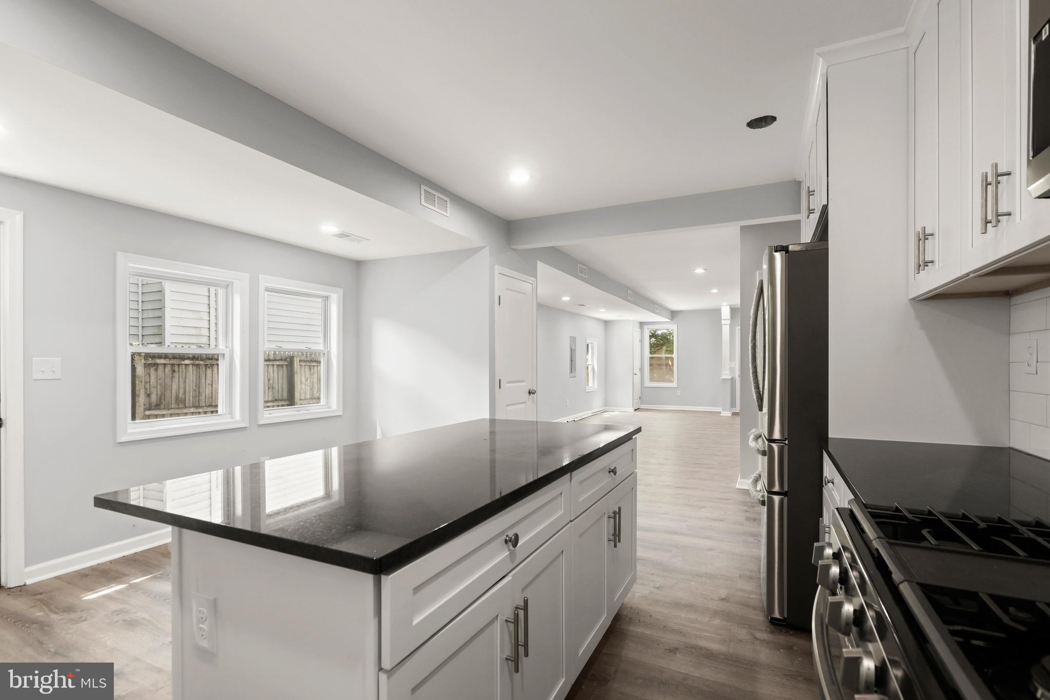 4015 Evans Chapel Road Baltimore, MD 21211 - Photo 19 of 50 a kitchen with granite countertop a sink and a stove