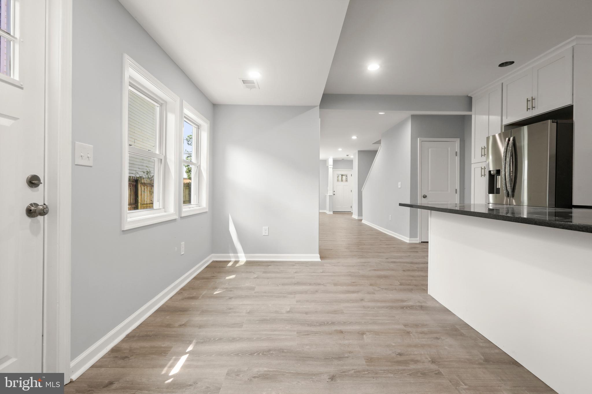 4015 Evans Chapel Road Baltimore, MD 21211 - Photo 21 of 50 a view of a hallway with wooden floor and a living room