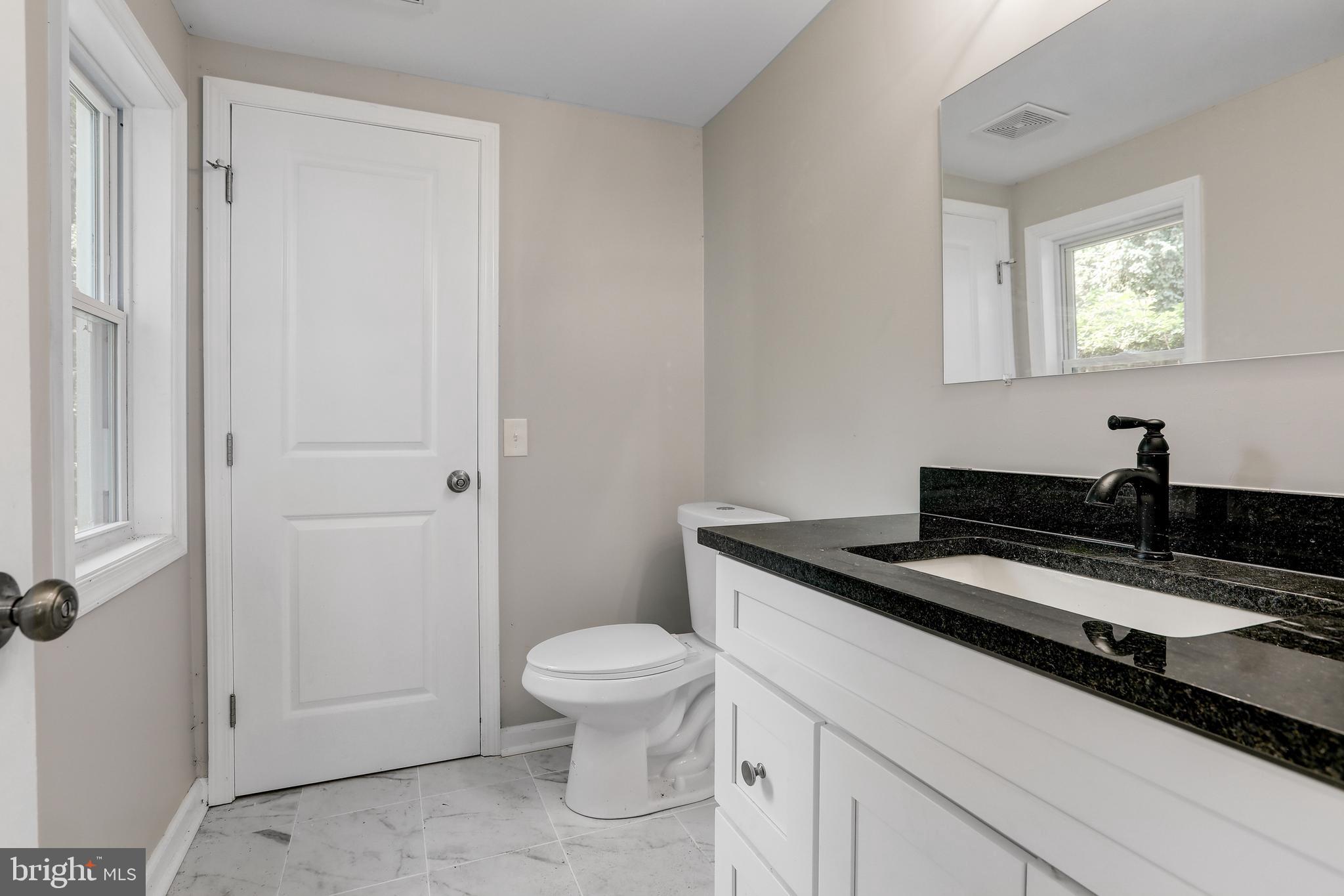 4015 Evans Chapel Road Baltimore, MD 21211 - Photo 23 of 50 a view of a bathroom with a sink and toilet