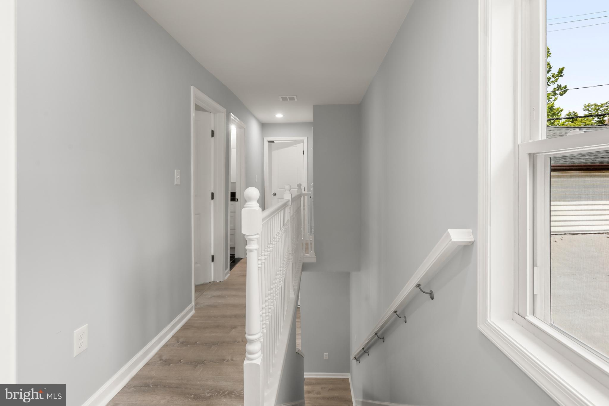 4015 Evans Chapel Road Baltimore, MD 21211 - Photo 25 of 50 a view of a hallway with wooden floor and staircase
