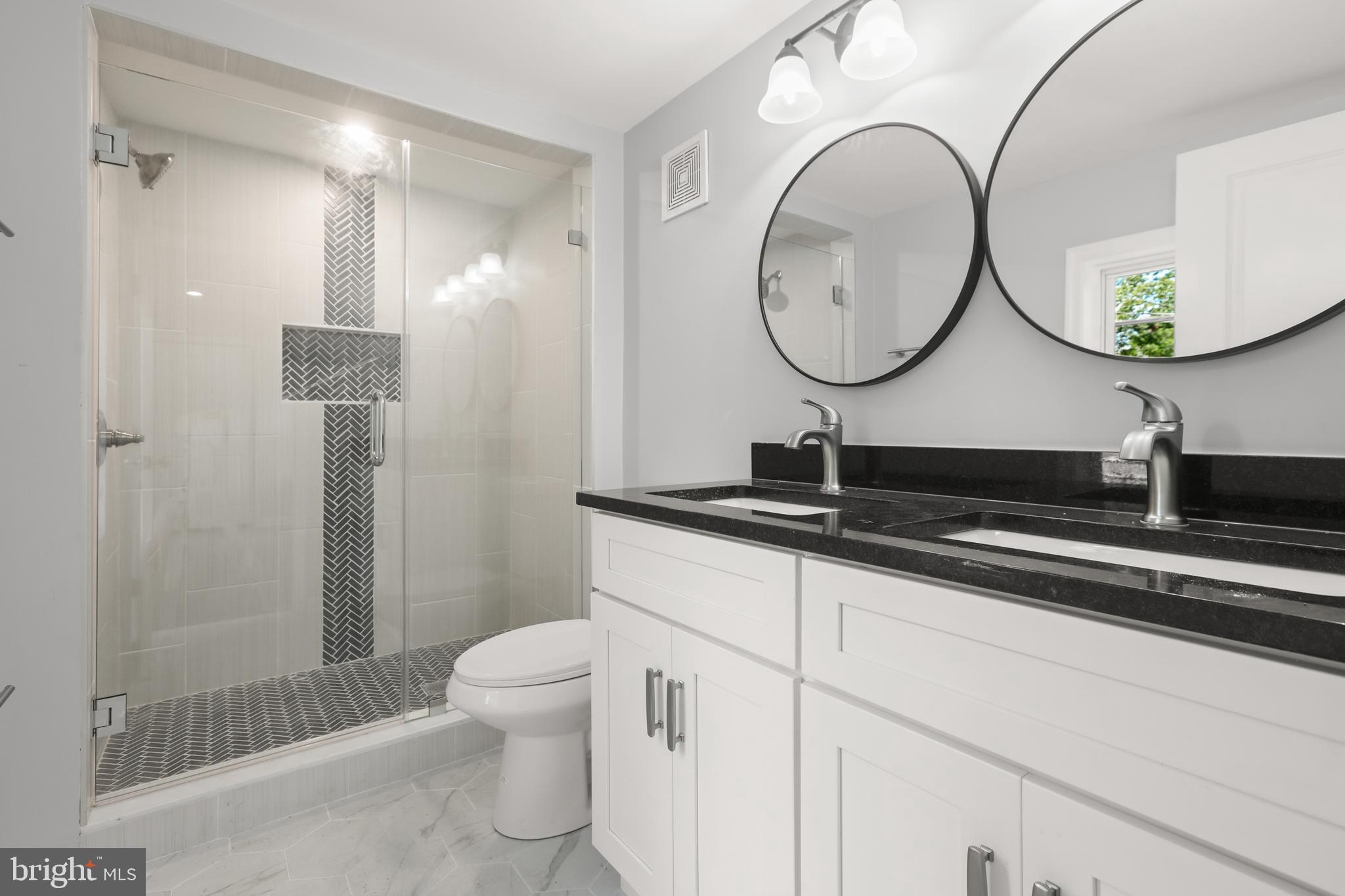 4015 Evans Chapel Road Baltimore, MD 21211 - Photo 30 of 50 a bathroom with a double vanity sink mirror and toilet