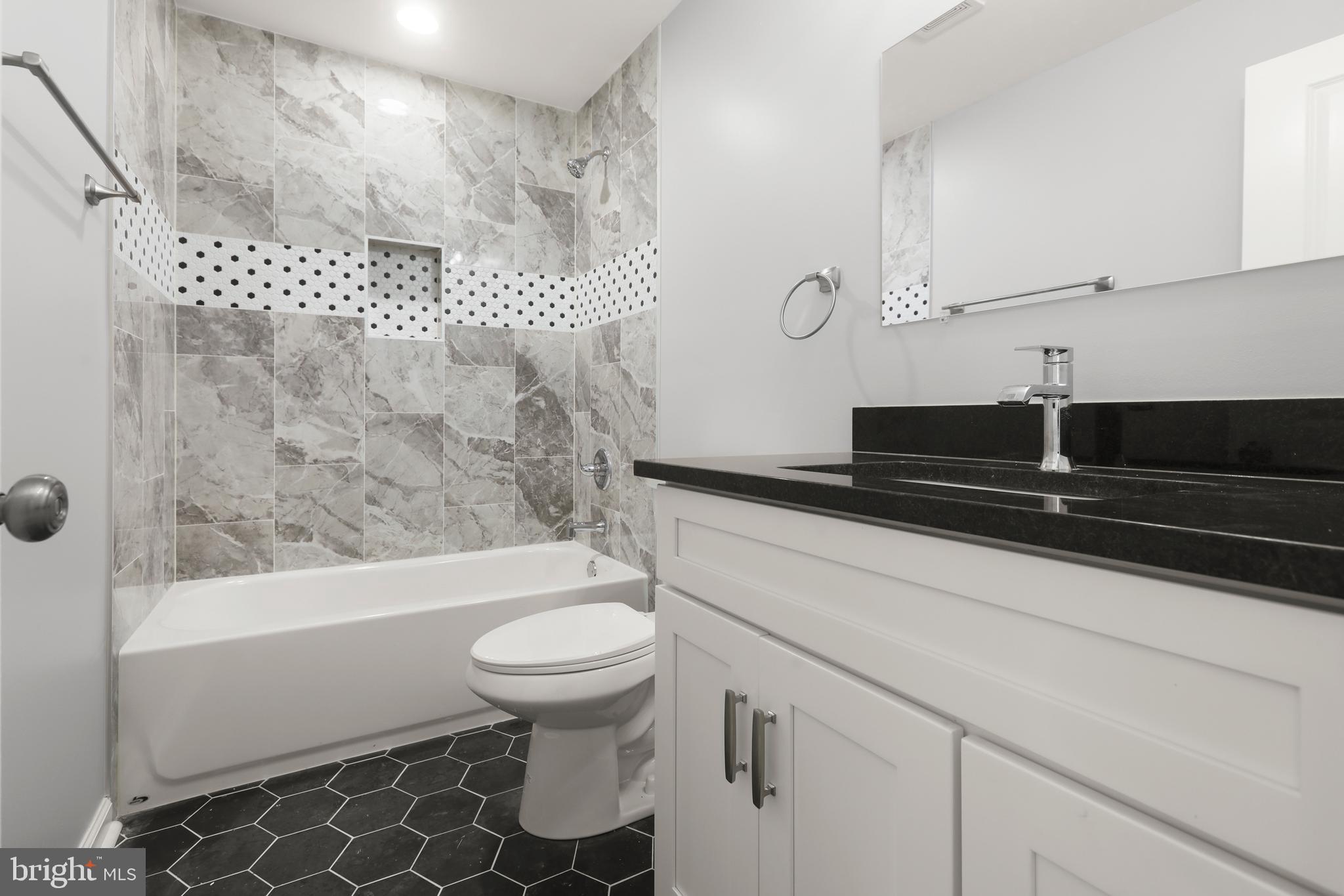 4015 Evans Chapel Road Baltimore, MD 21211 - Photo 35 of 50 a bathroom with a sink a toilet and a shower