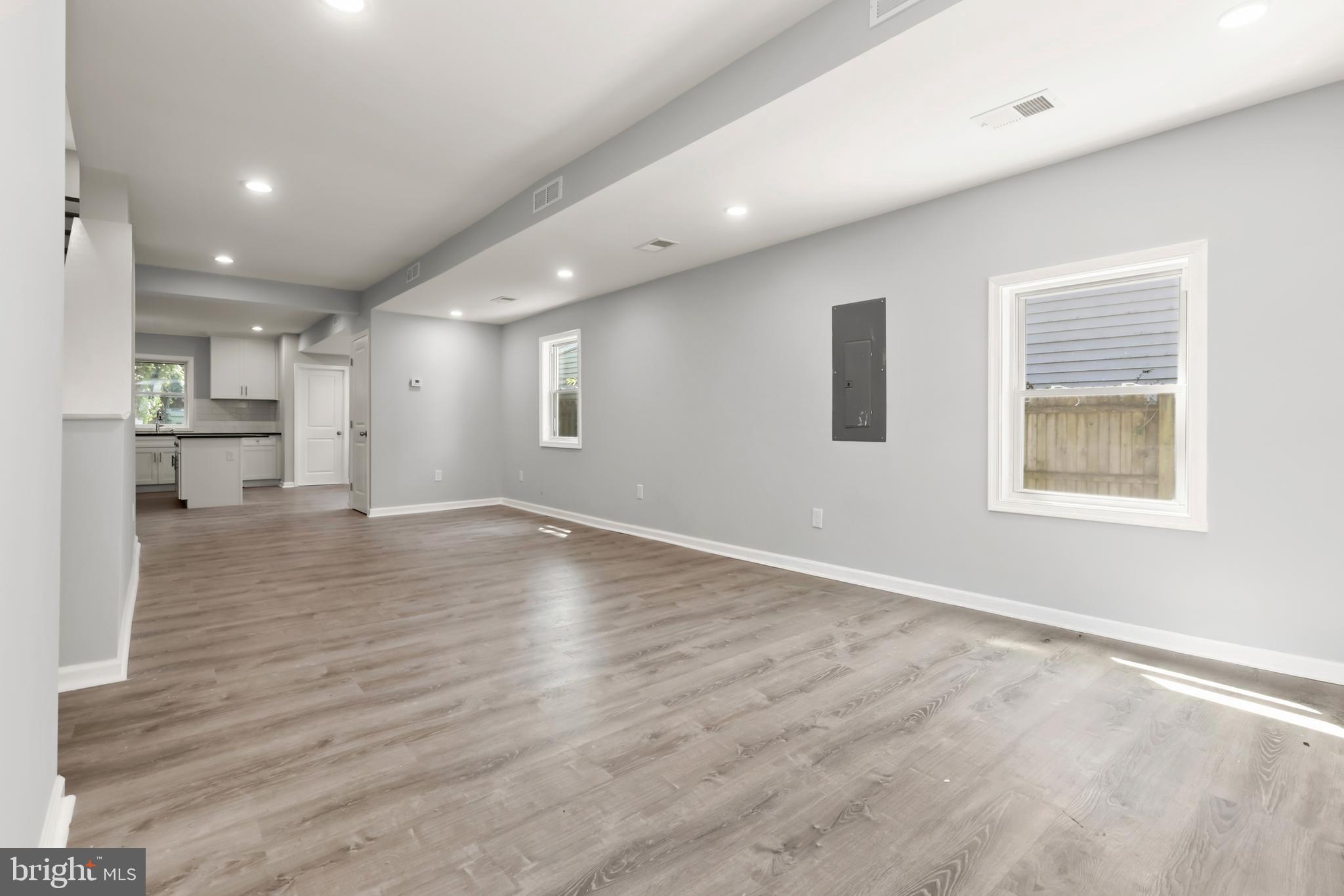 4015 Evans Chapel Road Baltimore, MD 21211 - Photo 8 of 50 an empty room with wooden floor and windows