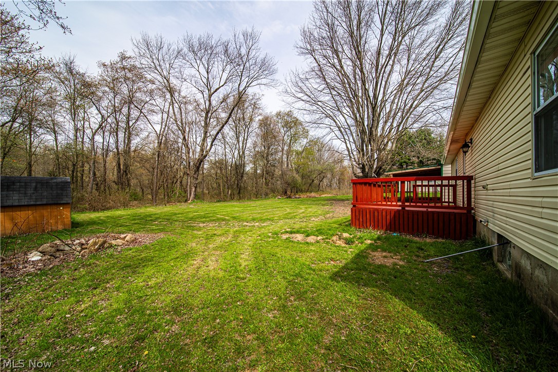 3501 Pymatuning Lake Road Andover, OH 44003 - Photo 8 of 36 View of yard with a deck and a storage unit