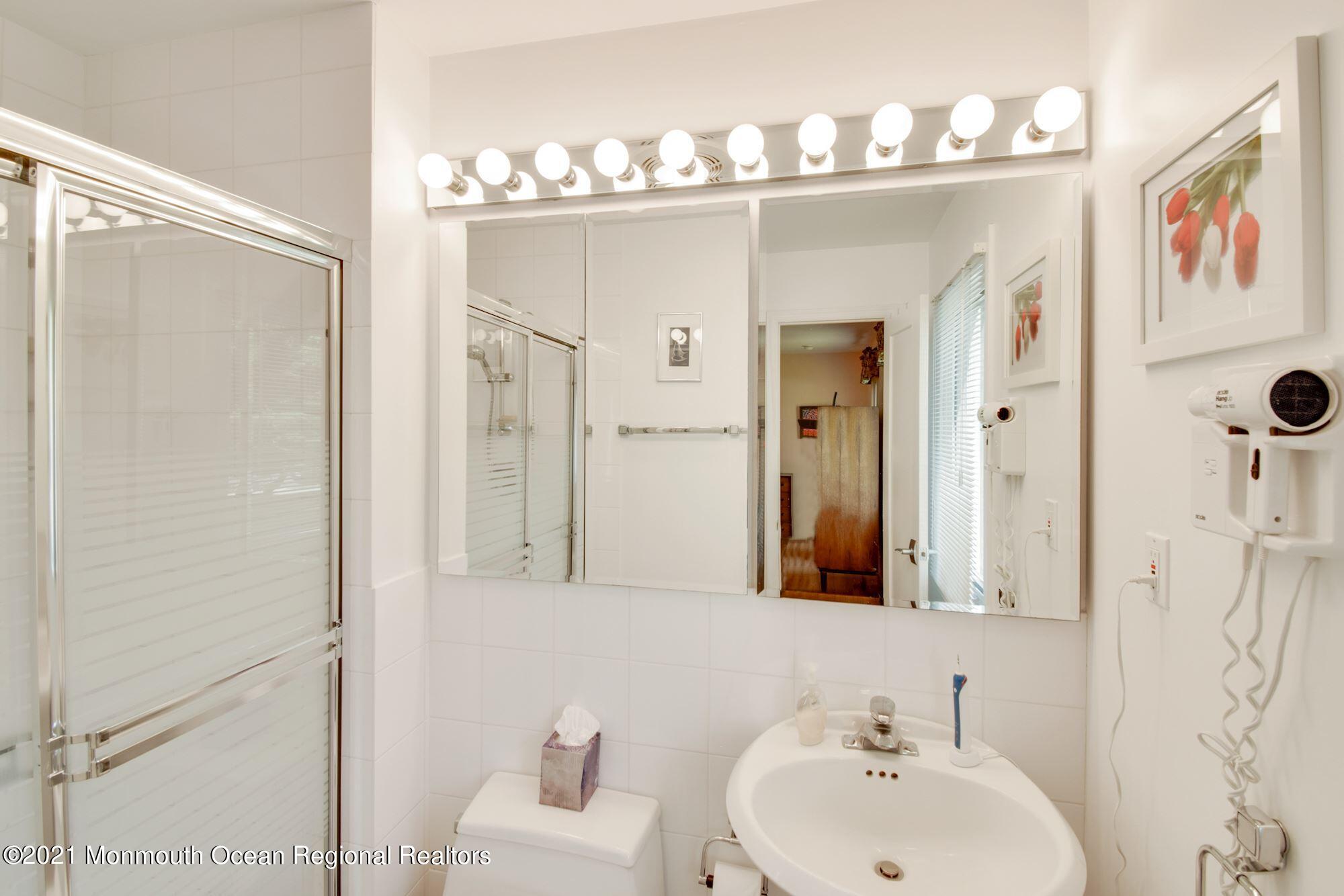 36 Coldspring Road Freehold, NJ 07728 - Photo 20 of 37 a bathroom with a sink mirror and a shower