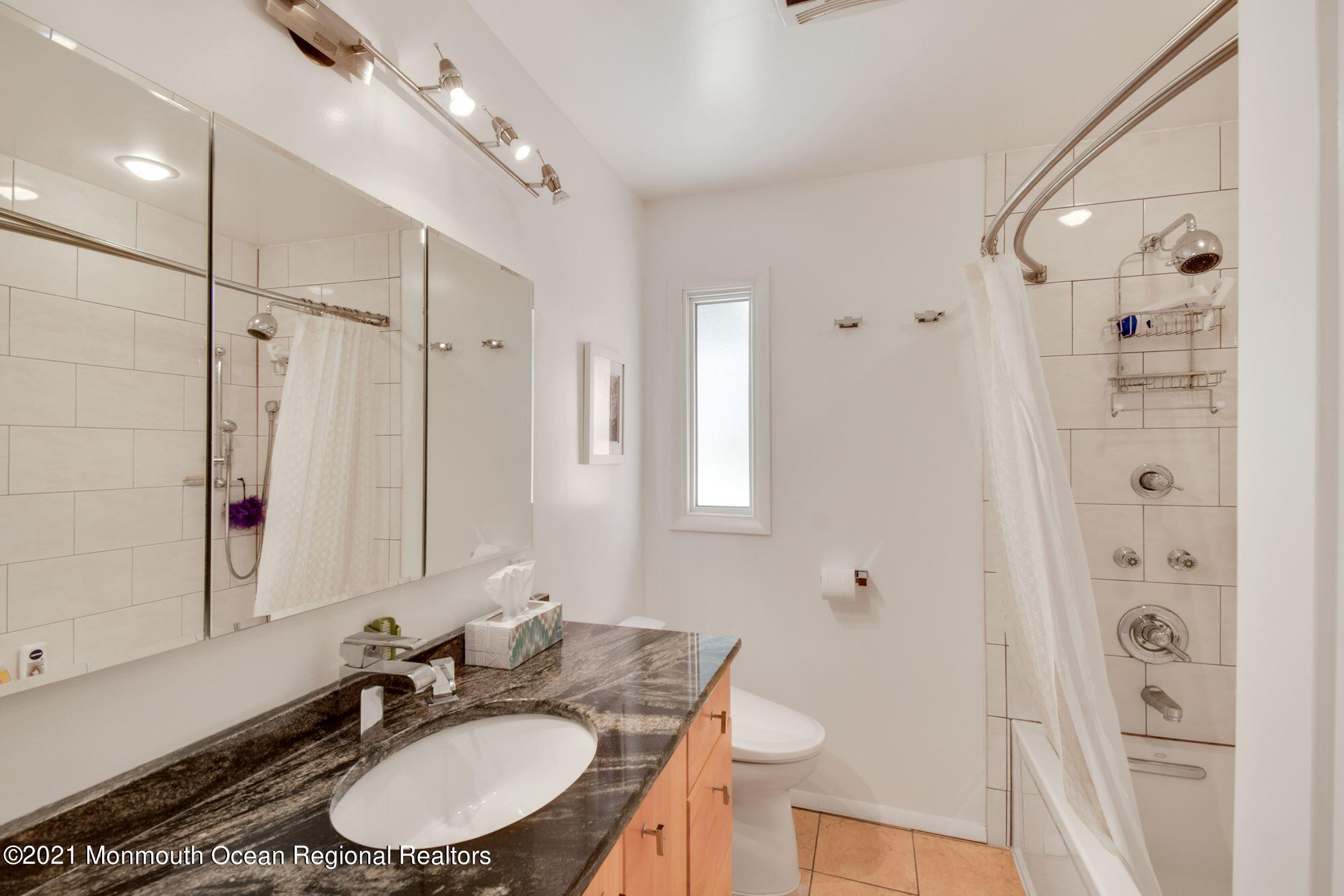 36 Coldspring Road Freehold, NJ 07728 - Photo 25 of 37 a bathroom with a granite countertop sink a mirror a toilet and shower