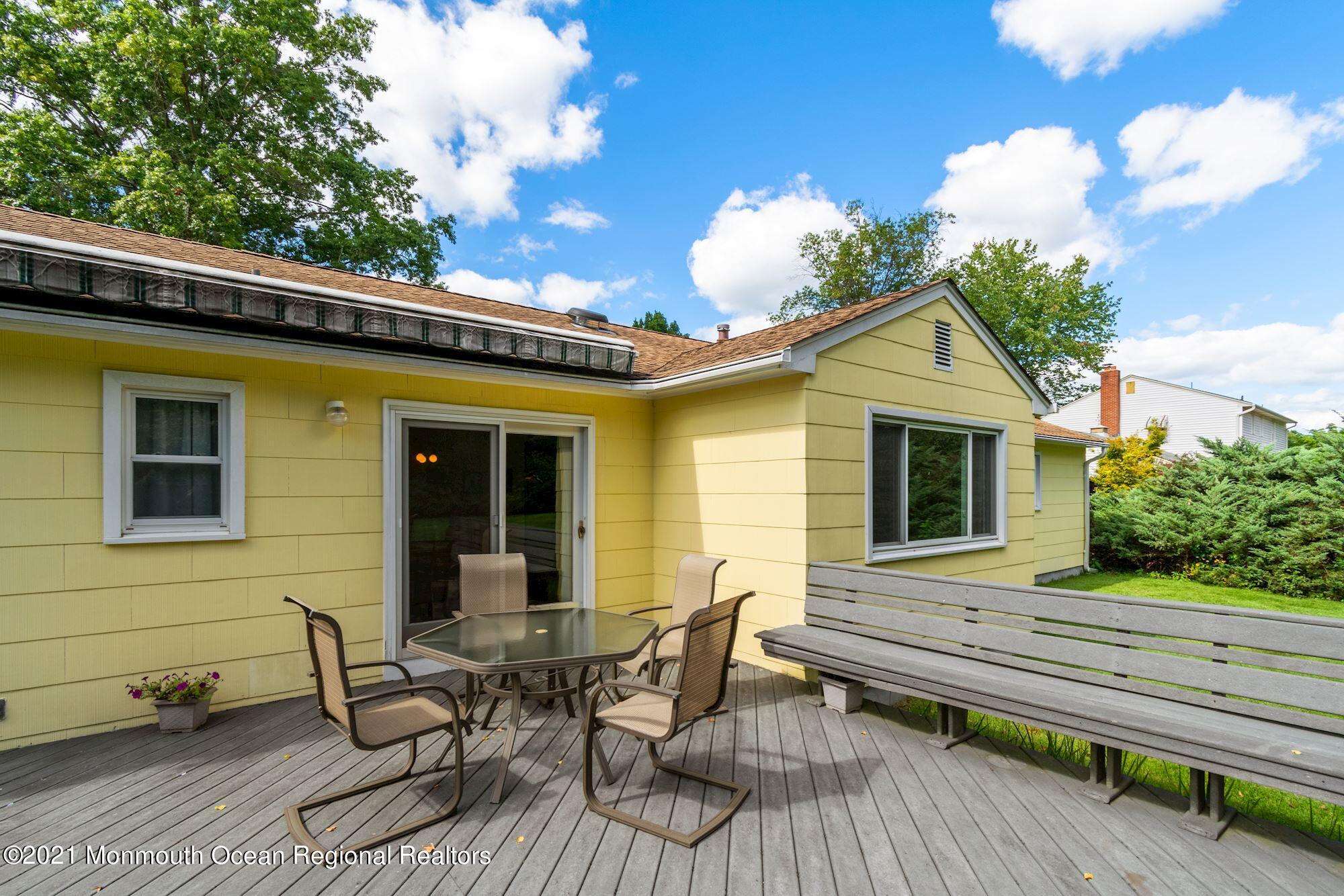 36 Coldspring Road Freehold, NJ 07728 - Photo 30 of 37 a view of a house with a chairs and table in a patio