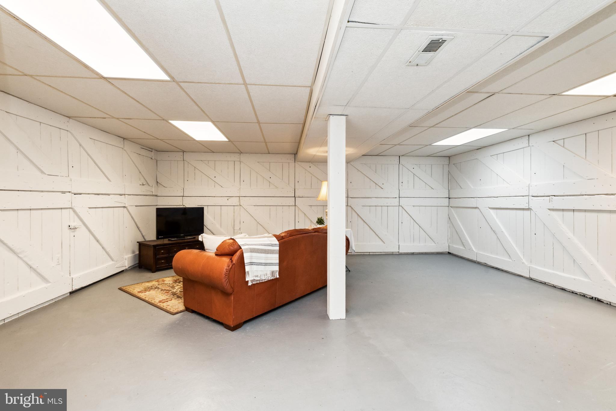 612 Old County Road Severna Park, MD 21146 - Photo 29 of 52 Lower Level Rec Room w/ Barn Door Storage Closets
