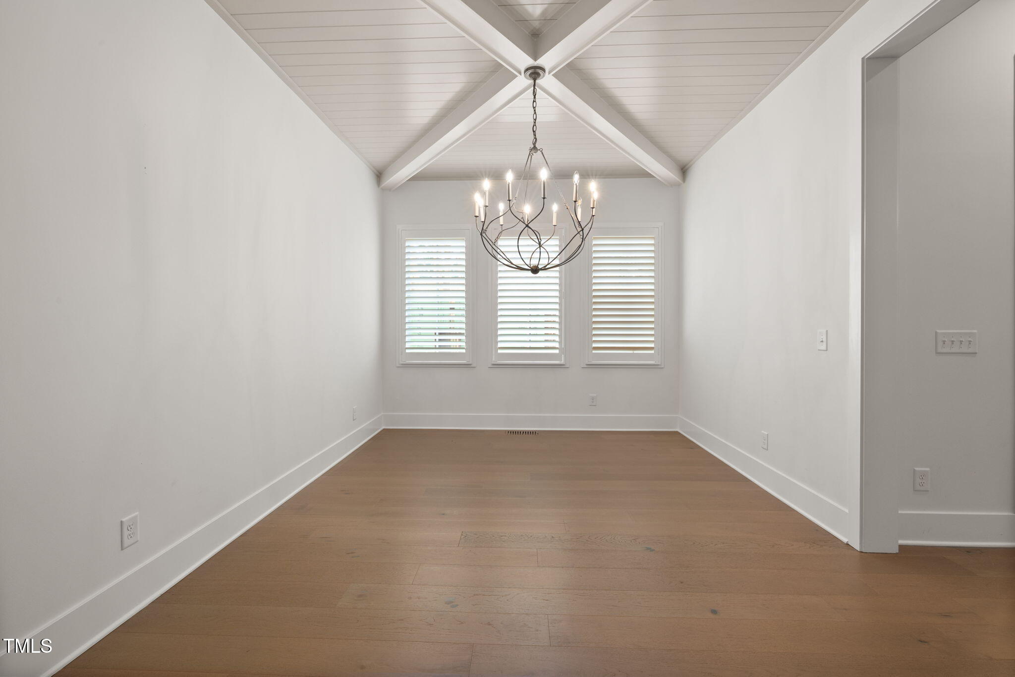 1212 Gunnison Place Raleigh, NC 27609 - Photo 13 of 53 en empty room with windows and chandelier
