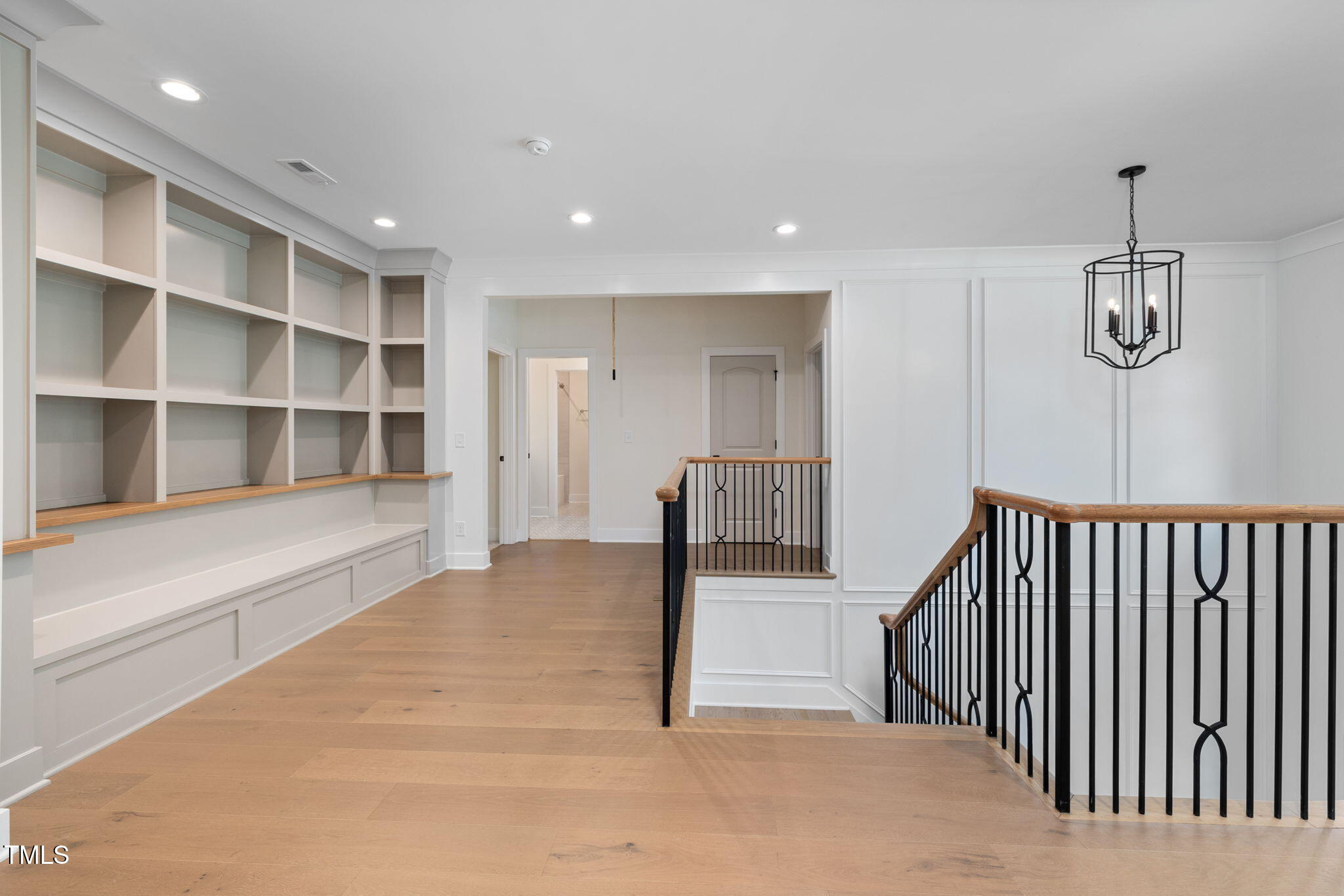 1212 Gunnison Place Raleigh, NC 27609 - Photo 33 of 53 a view of a hallway with wooden floor and cabinet