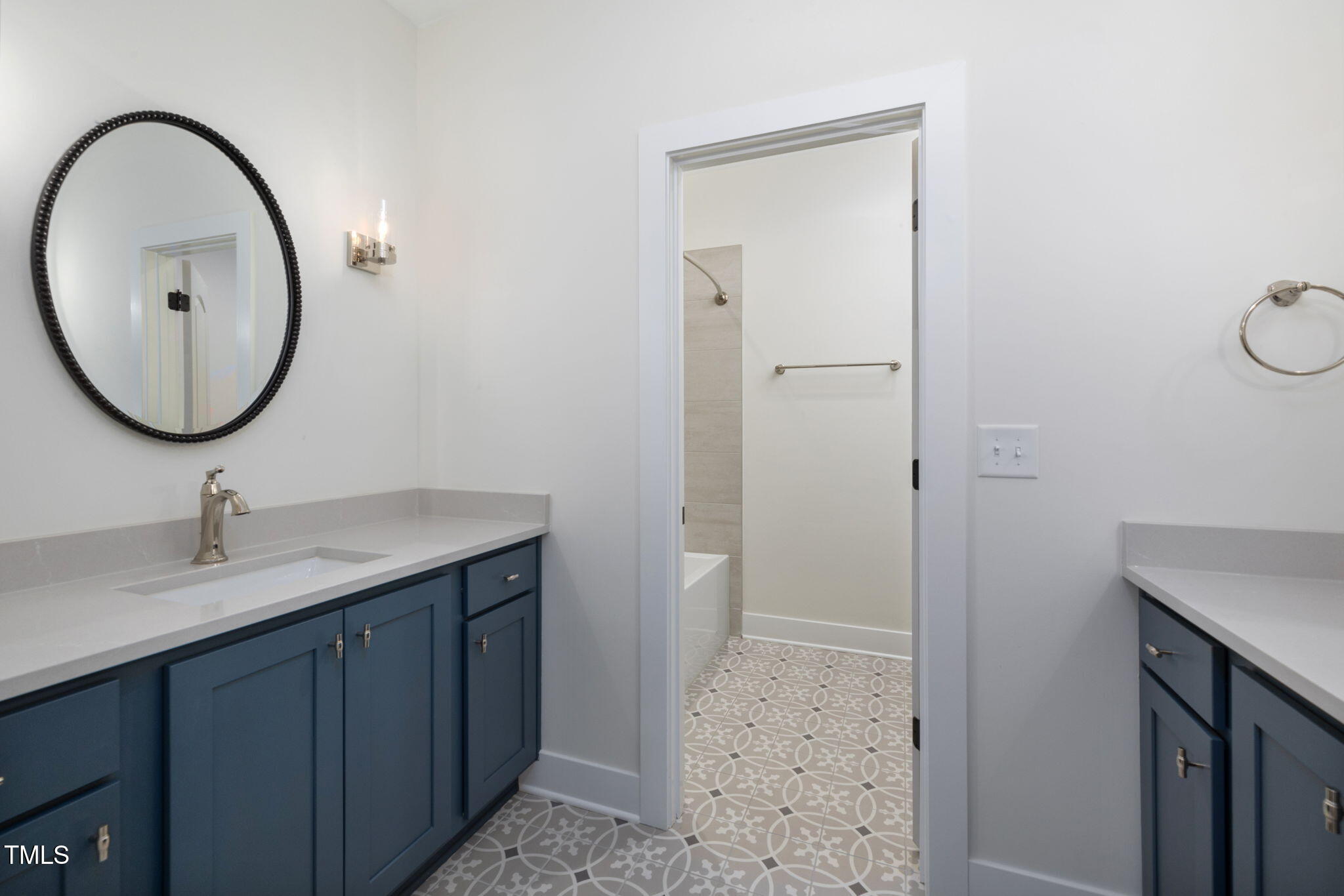 1212 Gunnison Place Raleigh, NC 27609 - Photo 38 of 53 a bathroom with a sink a mirror and a light fixture