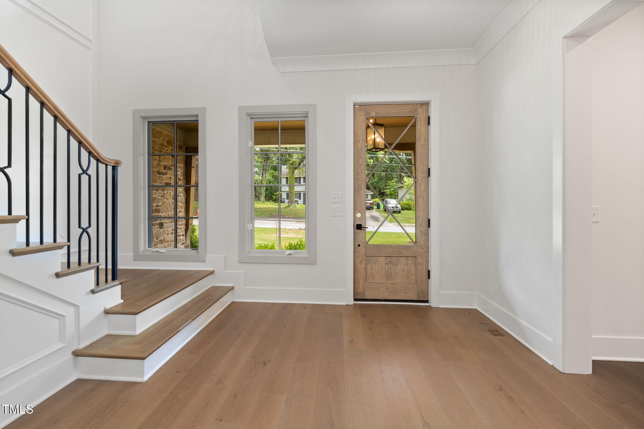 1212 Gunnison Place Raleigh, NC 27609 - Photo 6 of 53 a view of an entryway with wooden floor and door