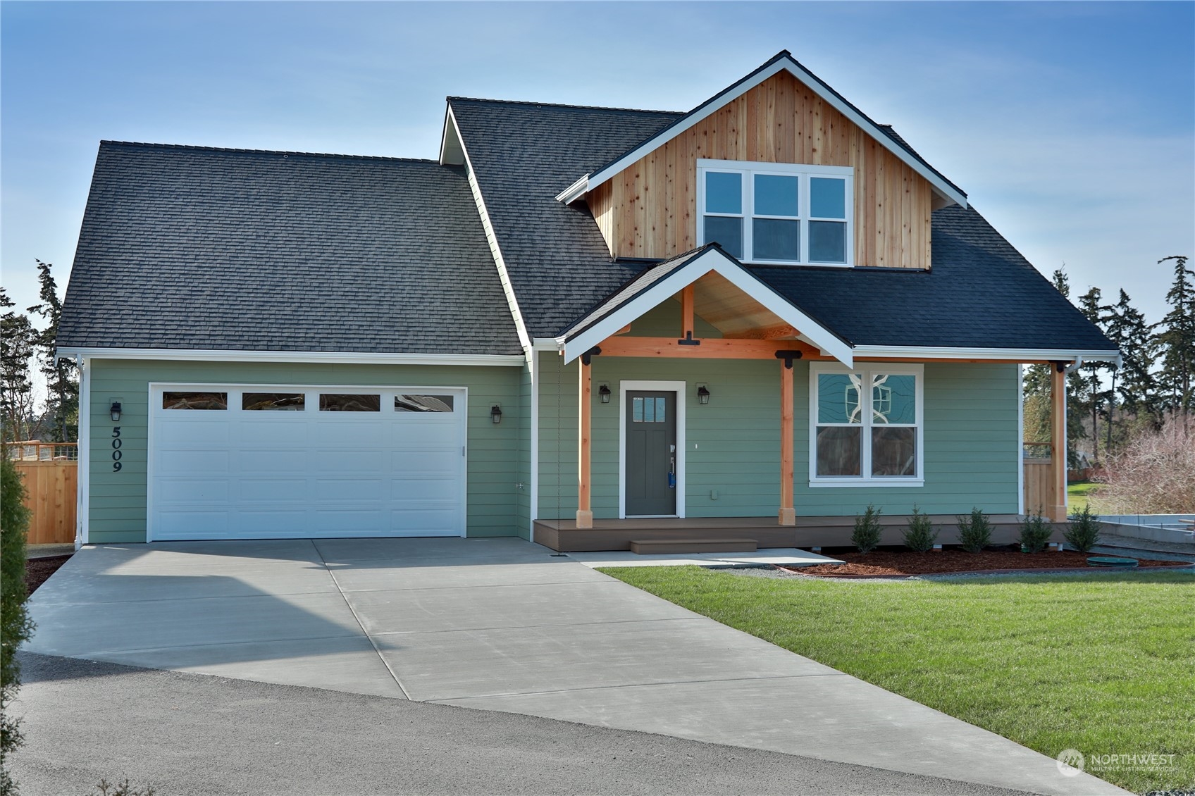 5009 Eagle Ridge Drive Freeland, WA 98249 - Photo 1 of 40 a front view of a house with a yard and garage