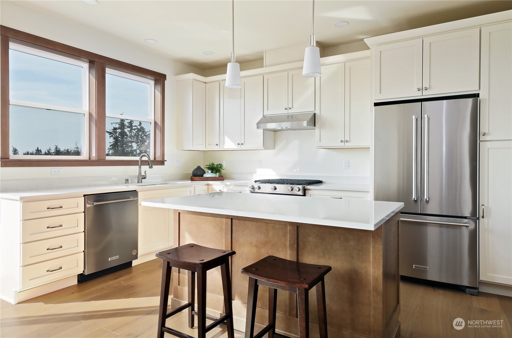 5009 Eagle Ridge Drive Freeland, WA 98249 - Photo 11 of 40 a kitchen with kitchen island white cabinets and stainless steel appliances
