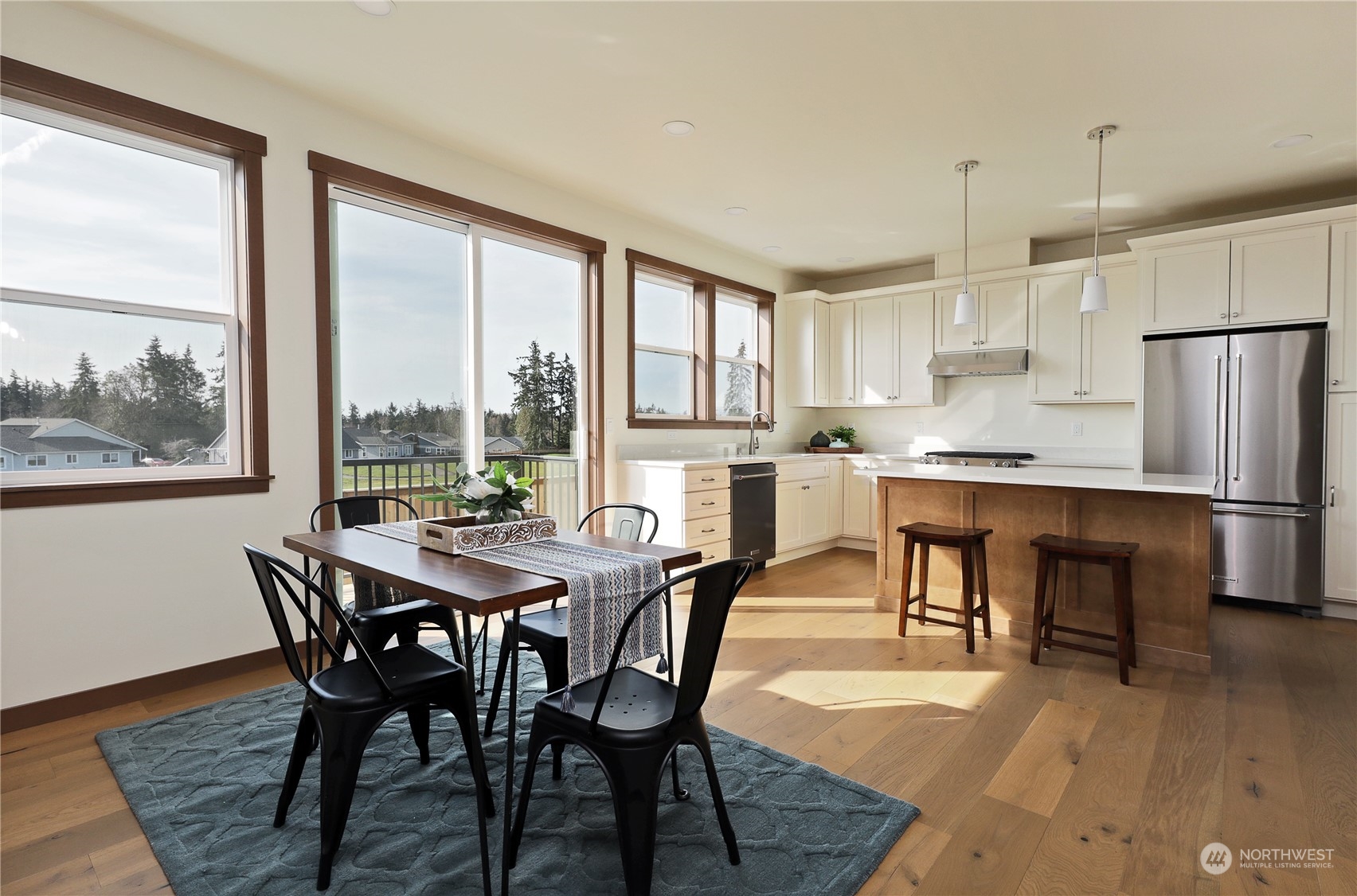 5009 Eagle Ridge Drive Freeland, WA 98249 - Photo 14 of 40 a dining room with furniture a large window and stainless steel appliances