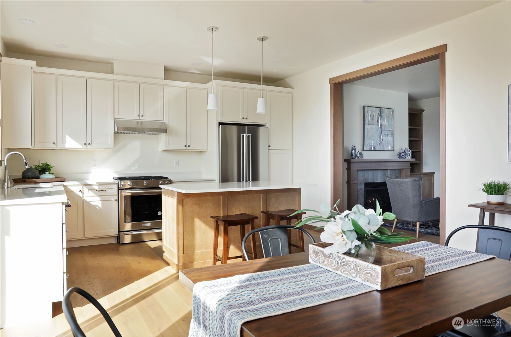 5009 Eagle Ridge Drive Freeland, WA 98249 - Photo 15 of 40 a kitchen with a table chairs refrigerator and cabinets