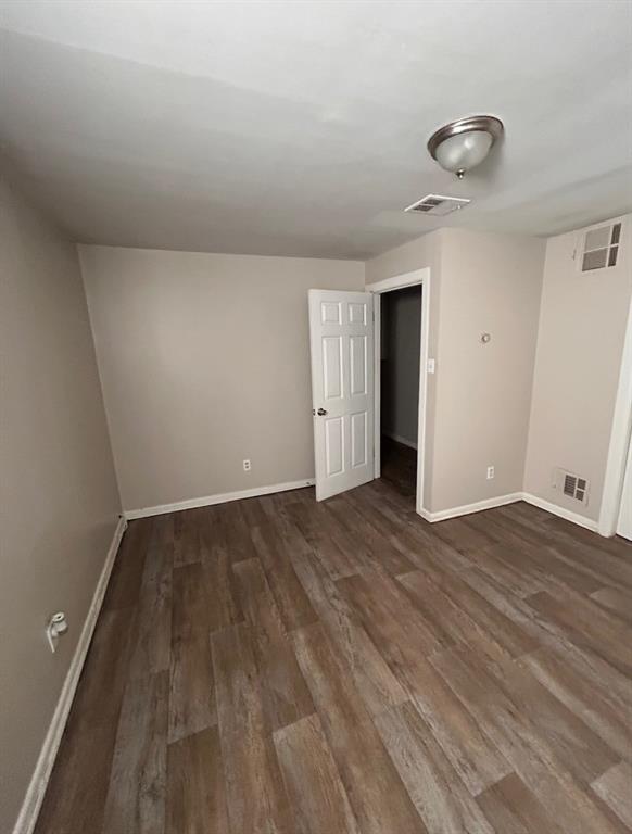 3149 Fulton Street Shreveport, LA 71109 - Photo 2 of 7 Empty room with dark wood finished floors and baseboards
