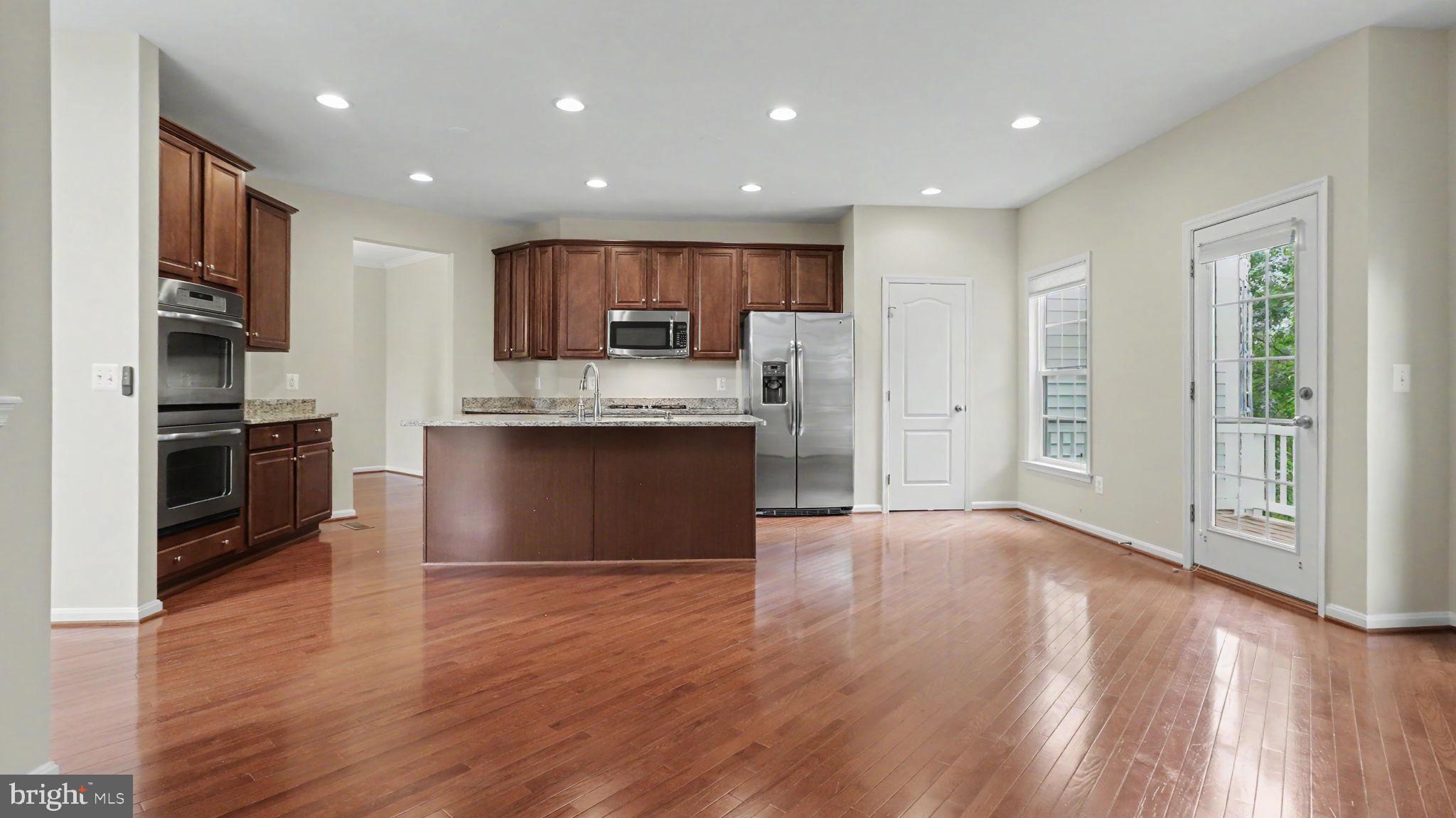 42371 Trellis Square Brambleton, VA 20148 - Photo 27 of 70 Modern kitchen with warm wood tones.