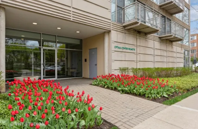 a flower garden with wooden fence