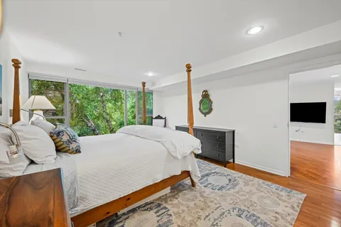 a bedroom with a bed and wooden floor