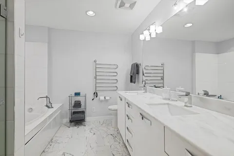 a spacious bathroom with a sink a vanity and a mirror