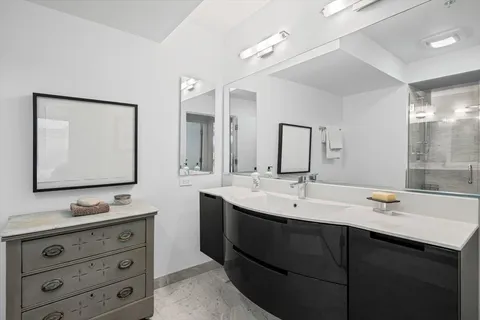 a bathroom with double sink and a mirror