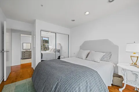 a bedroom with a large bed and a chandelier