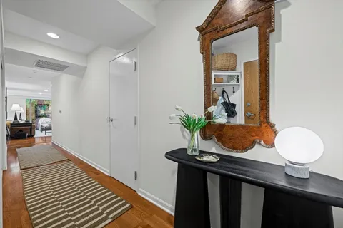 a view of a dining room with a table and chairs