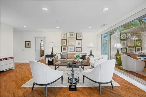 a living room with fireplace furniture and a large window