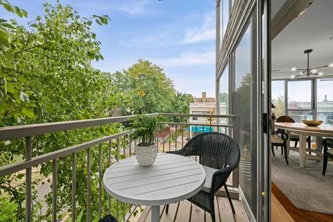 a view of a balcony with table and chairs