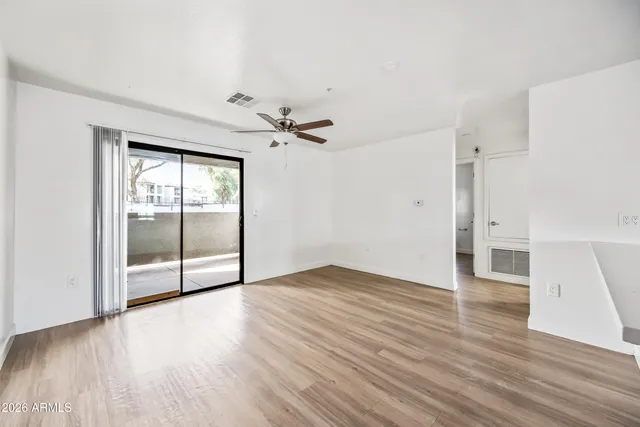 wooden floor in an empty room with a window