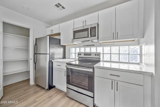 a kitchen with stainless steel appliances granite countertop a stove and a sink