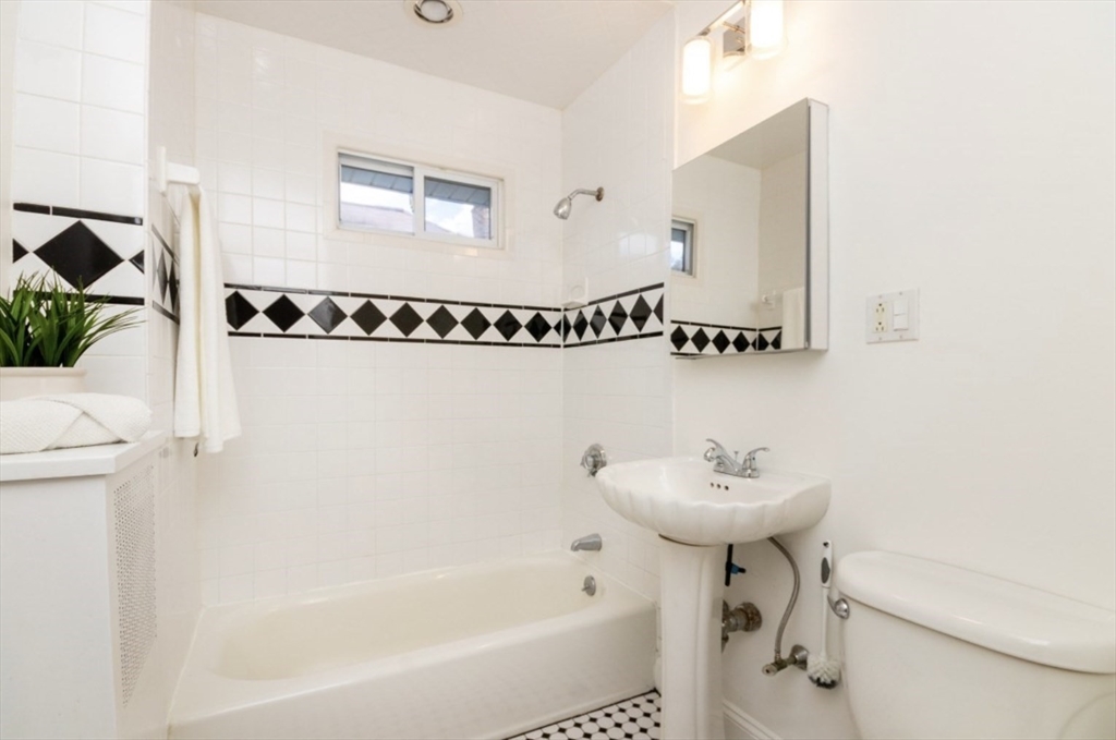 33 Pierce Avenue, Unit 2 Boston, MA 02122 - Photo 12 of 16 a bathroom with a sink a mirror and a shower