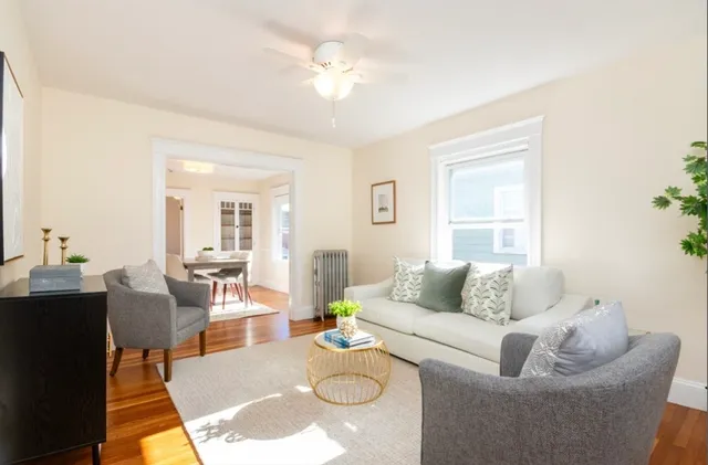 a living room with furniture and a large window