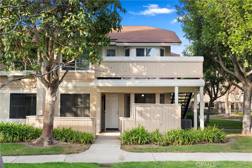 a front view of a house with a yard garage and outdoor seating