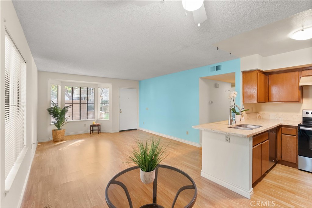 12621 Moordale Circle, Unit G Stanton, CA 90680 - Photo 11 of 36 a view of a kitchen with a sink and a large window
