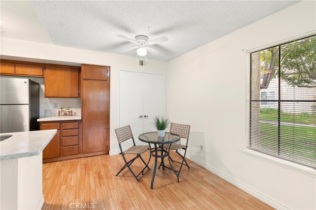12621 Moordale Circle, Unit G Stanton, CA 90680 - Photo 12 of 36 a view of a dining room with furniture window and wooden floor