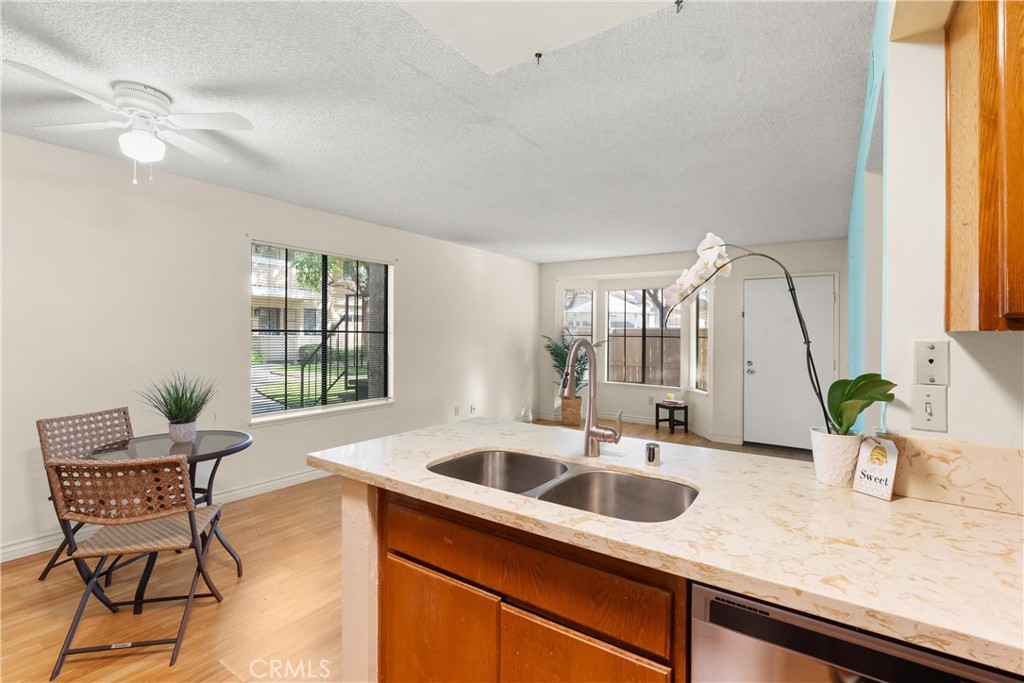 12621 Moordale Circle, Unit G Stanton, CA 90680 - Photo 17 of 36 a kitchen with a sink cabinets and window