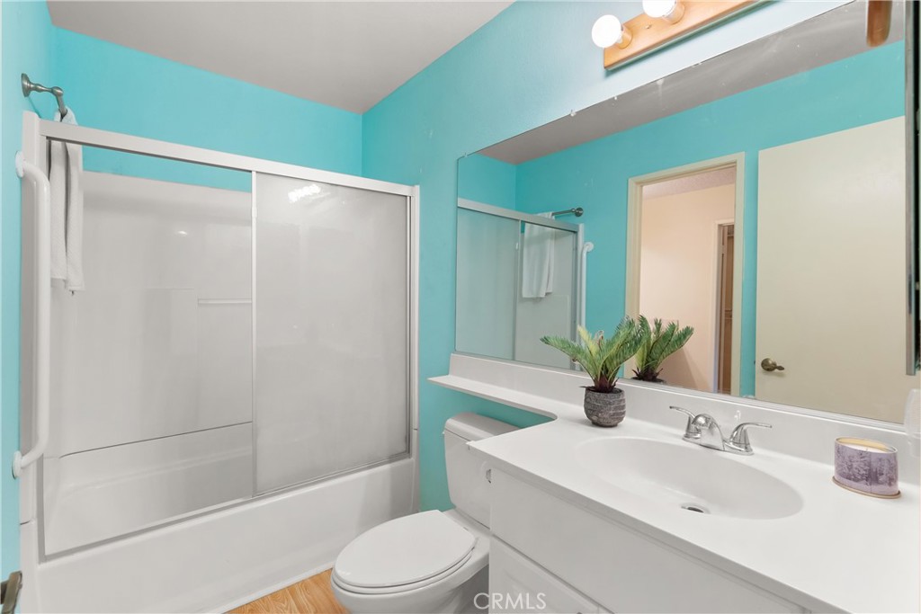 12621 Moordale Circle, Unit G Stanton, CA 90680 - Photo 18 of 36 a bathroom with a sink a toilet a mirror and shower