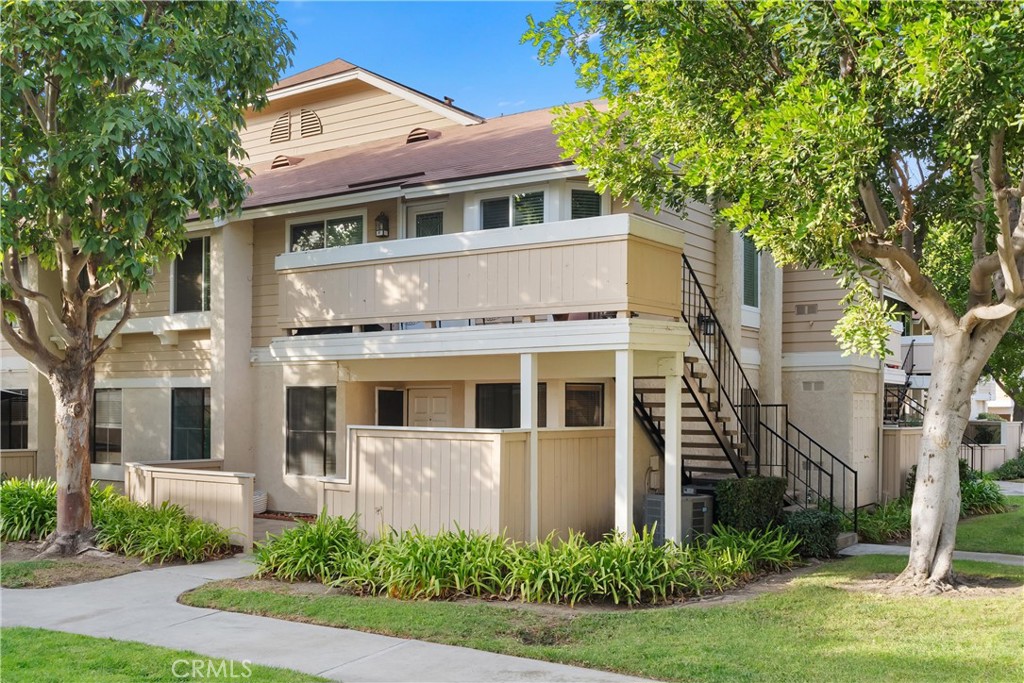 12621 Moordale Circle, Unit G Stanton, CA 90680 - Photo 2 of 36 a front view of a house with a yard garage and outdoor seating