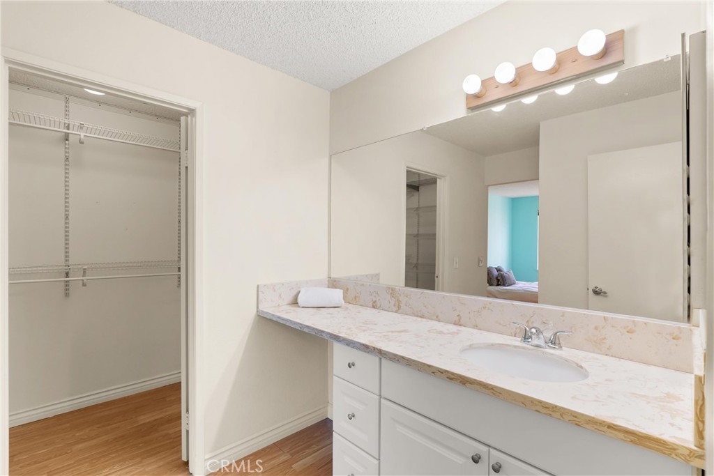 12621 Moordale Circle, Unit G Stanton, CA 90680 - Photo 24 of 36 a bathroom with a double vanity sink and a mirror