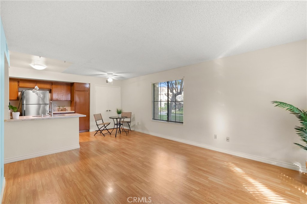 12621 Moordale Circle, Unit G Stanton, CA 90680 - Photo 8 of 36 a living room with furniture and a table with wooden floor