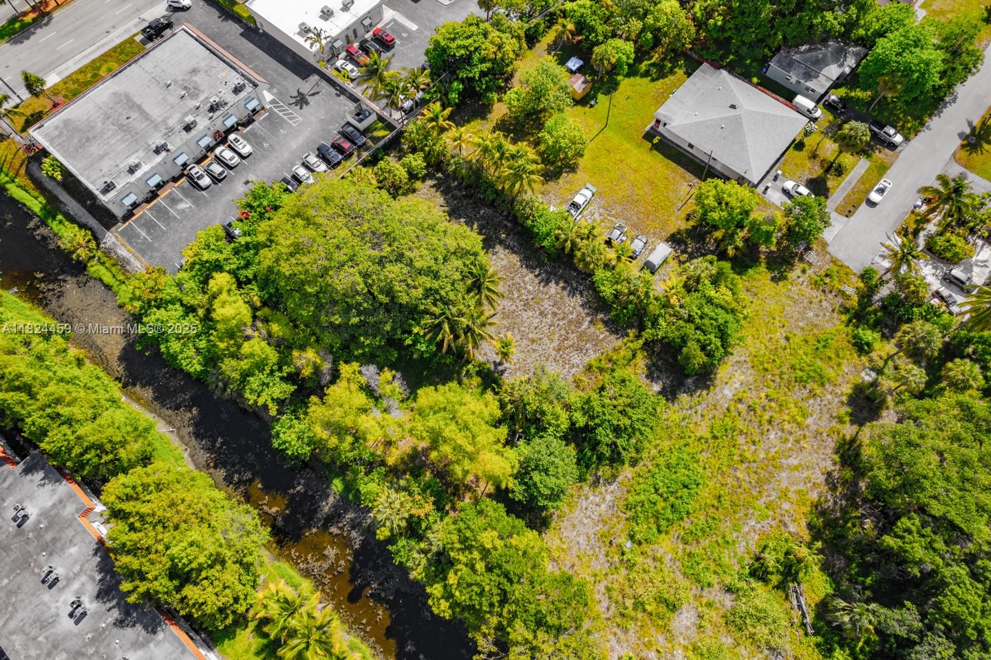 6214 Edwards Road Pompano Beach, FL 33063 - Photo 24 of 41 an aerial view of a house with a yard and garden