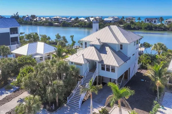 an aerial view of a house with outdoor space and lake view