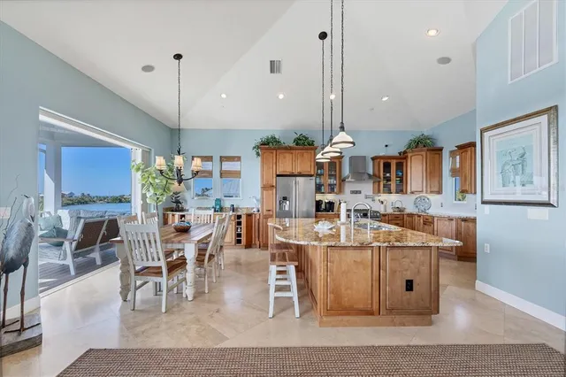 a living room with table chairs and a fireplace