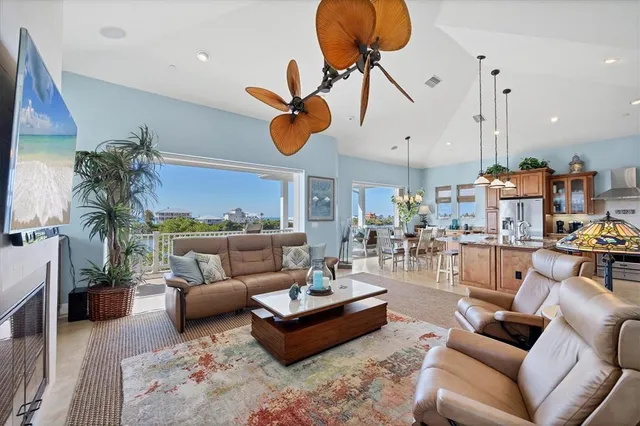 a living room with wooden floor and potted plant