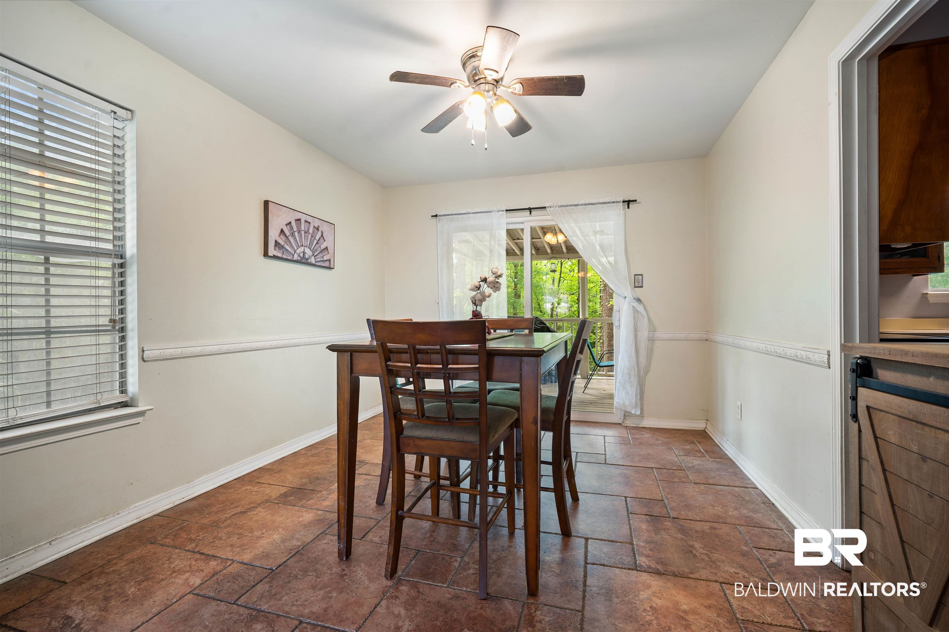 2823 Woodland Road Mobile, AL 36693 - Photo 10 of 29 Dining space featuring stone tile floors, a ceiling fan, and baseboards